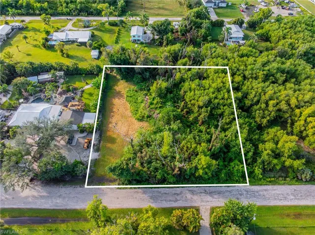 Aerial view of property and surrounding area featuring property parcel outlined