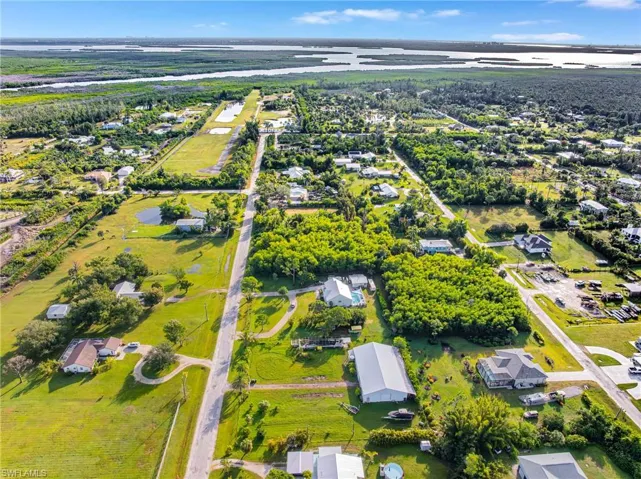 Aerial view of property's location featuring a large body of water and nearby suburban area