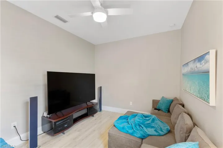 Living room featuring ceiling fan and light wood-type flooring