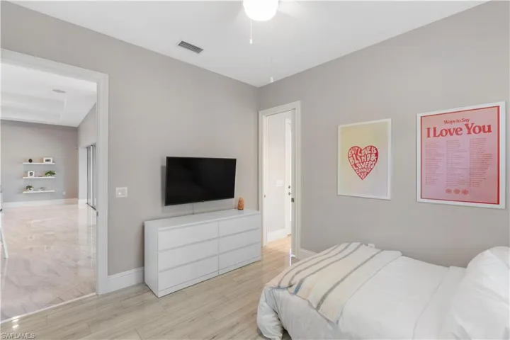 Bedroom featuring ceiling fan and light ceramic tile flooring
