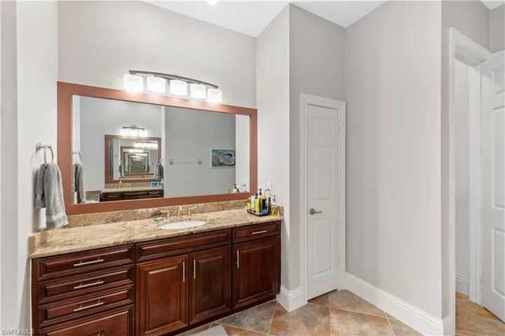 Owners bathroom with vanity and simulated stone ceramic tile