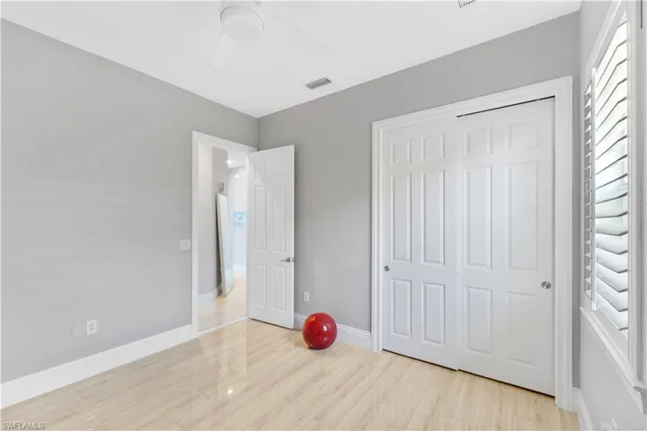 Unfurnished bedroom with ceiling fan, a closet, and light ceramic tile flooring
