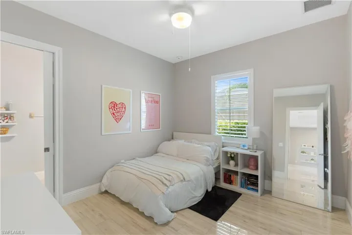 Bedroom featuring light ceramic tile flooring  and ceiling fan