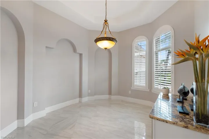 Dining space with a tray ceiling