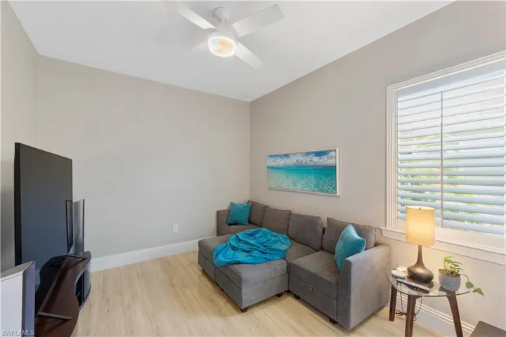 Bedroom / TV room featuring a wealth of natural light, light ceramic tile flooring and ceiling fan