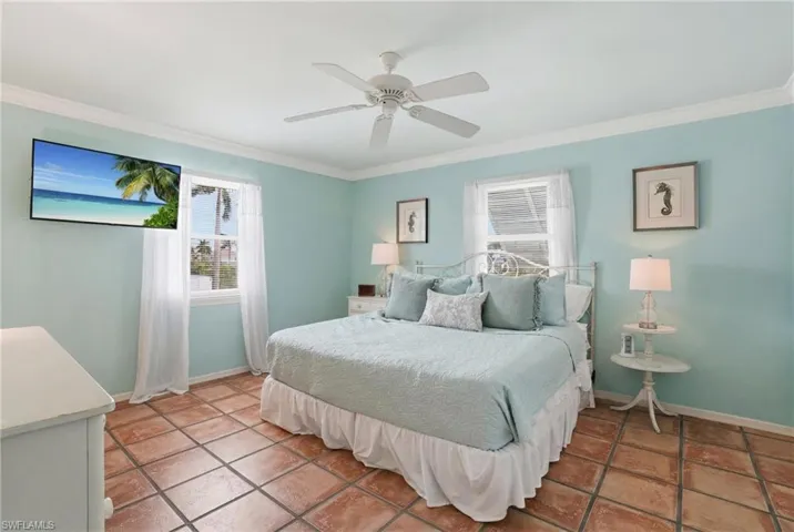 Room featuring terra cotta tile flooring and light blue walls - Virtually Edited Image