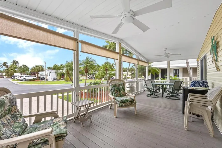 Sunroom / solarium featuring outdoor dining area, ceiling fan, and lofted ceiling