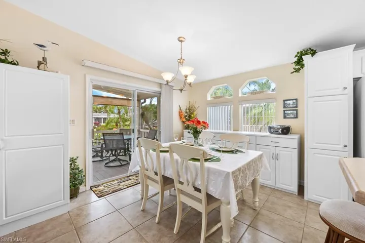 Dining room featuring light tile patterned floors and a chandelier
