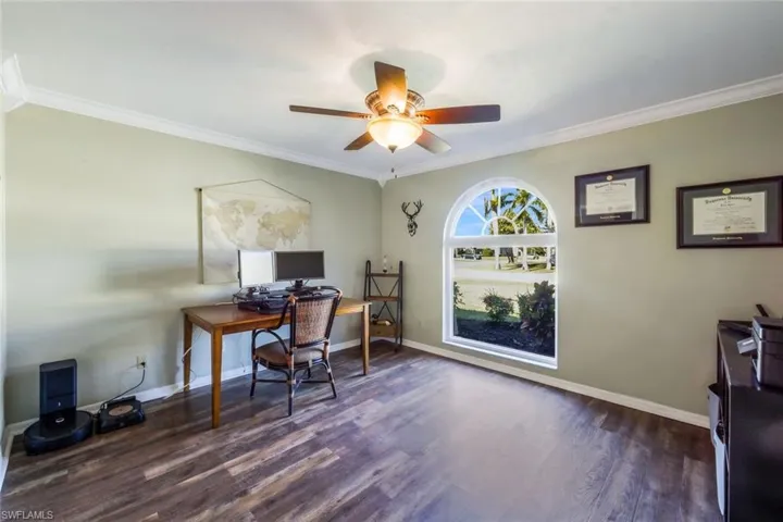 Office featuring ceiling fan, ornamental molding, and dark hardwood / wood-style floors