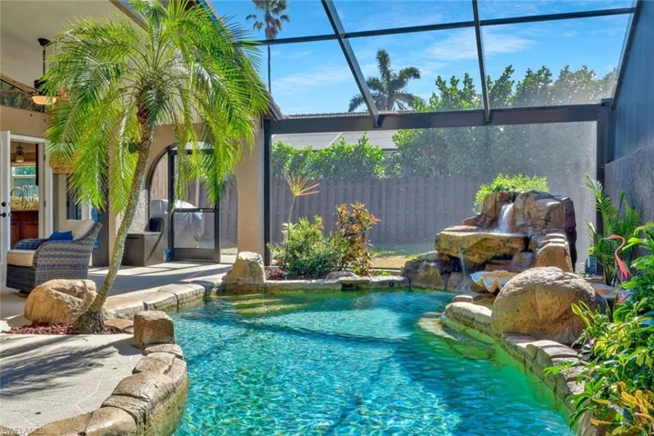 View of pool with fountain water feature, and a screen area