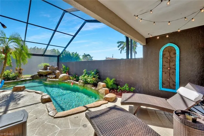 View of patio / terrace with a fenced in pool and a lanai from Master Bedroom entrance