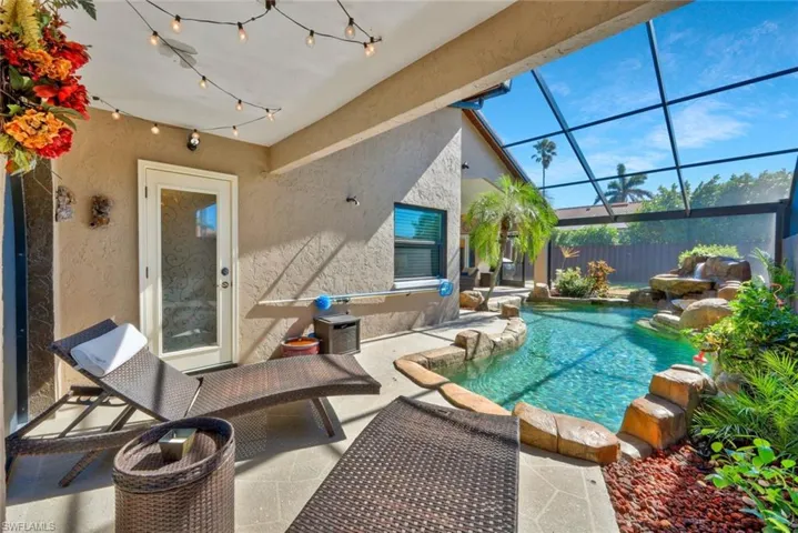 View of pool with a patio and screen enclosure