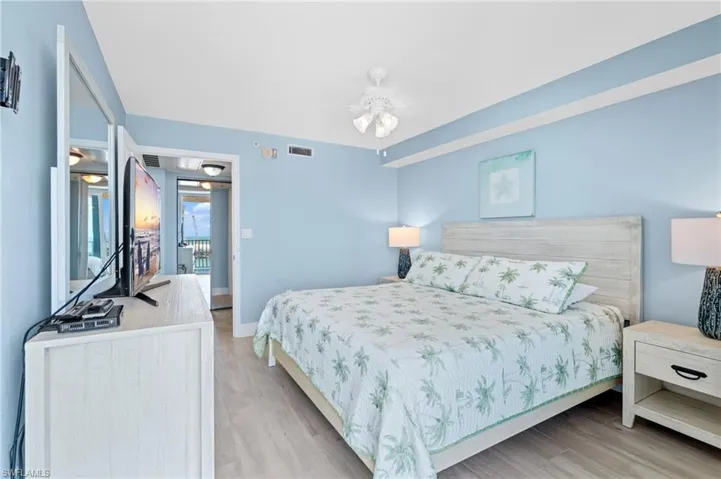 Bedroom with baseboards, visible vents, and light wood-style floors