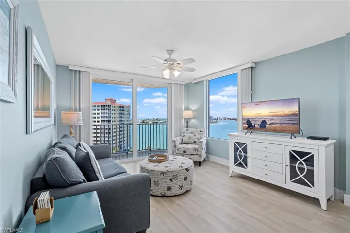 Living area featuring light wood finished floors, baseboards, and ceiling fan