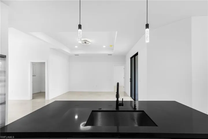 Kitchen featuring pendant lighting and a tray ceiling