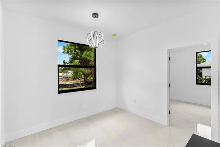 Unfurnished room featuring an inviting chandelier