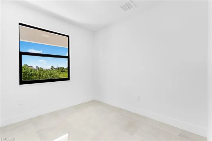 Unfurnished room with light tile patterned floors