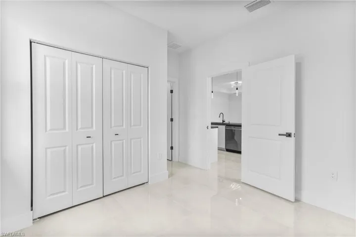 Unfurnished bedroom featuring sink and a closet