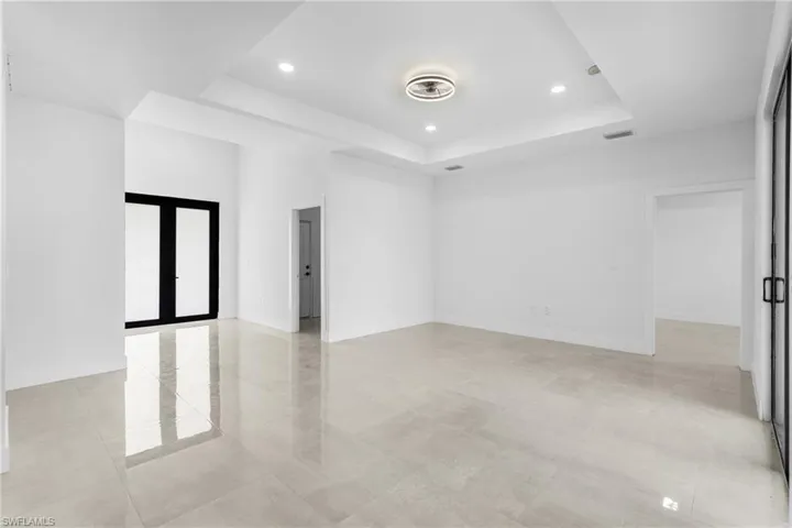 Spare room featuring a tray ceiling