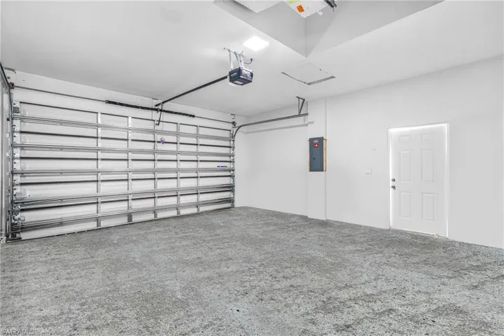 Garage with electric panel and a garage door opener