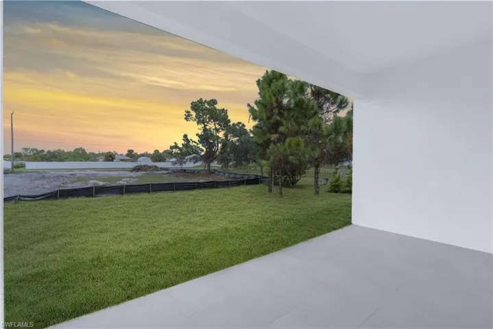 Yard at dusk featuring a patio area