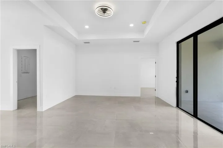 Empty room featuring a tray ceiling