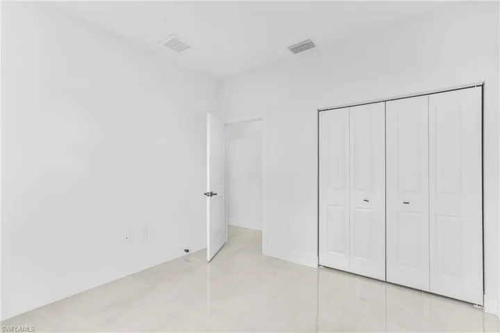 Unfurnished bedroom with light tile patterned floors and a closet