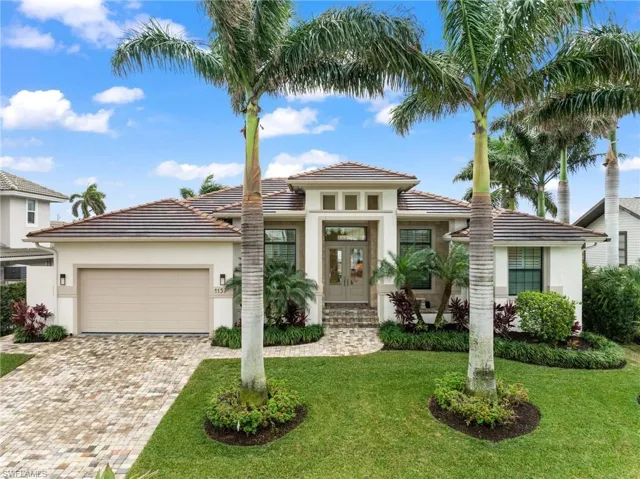 View of front of property with a garage, a front yard, and french doors