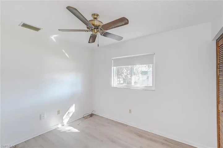 Unfurnished room featuring ceiling fan and light hardwood / wood-style flooring