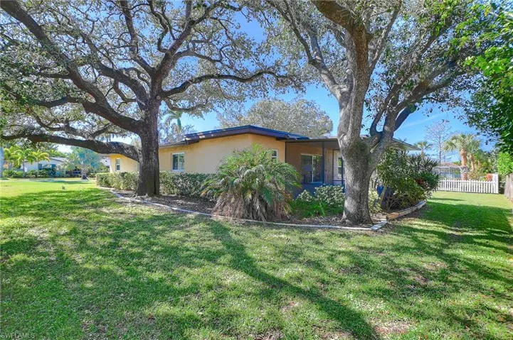 View of property exterior with a lawn