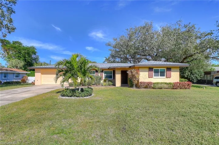 Ranch-style home with a garage and a front yard