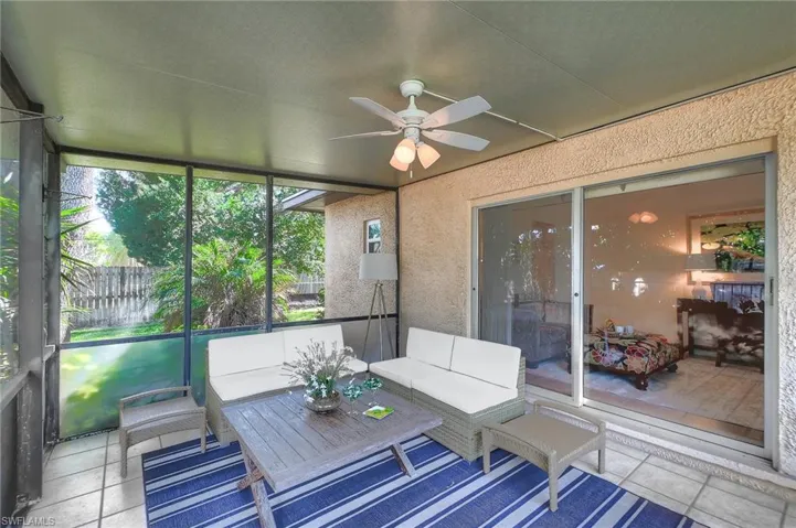 Unfurnished sunroom with ceiling fan