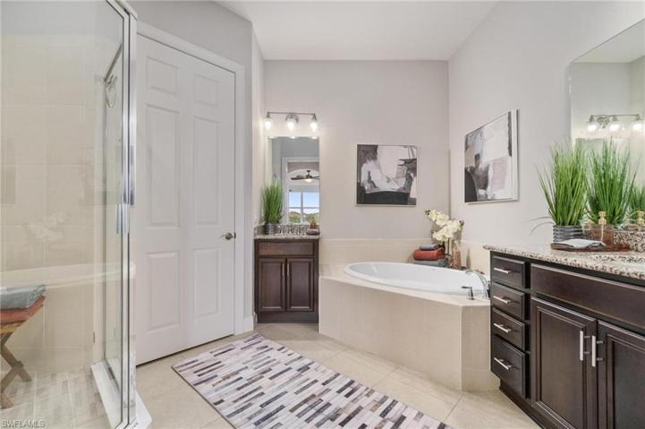 Expansive primary en-suite bath included walk in tiled shower, soaking tub and private toilet closet.
