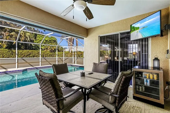 View of patio / terrace with a fenced in pool, a lanai, and ceiling fan