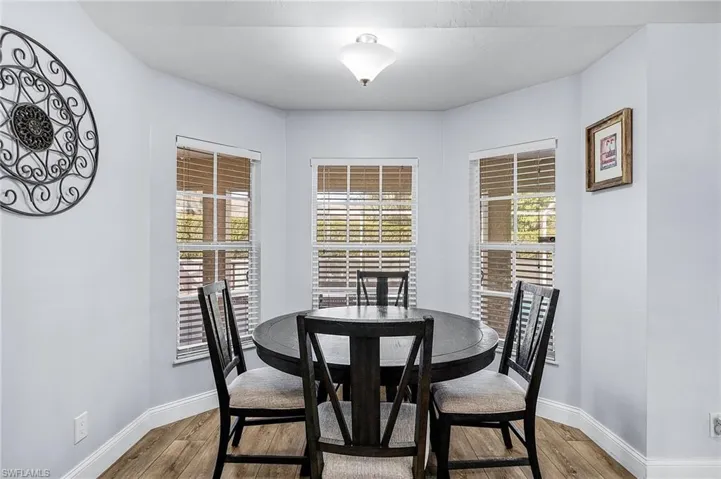 Dining space featuring a healthy amount of sunlight and wood-type flooring