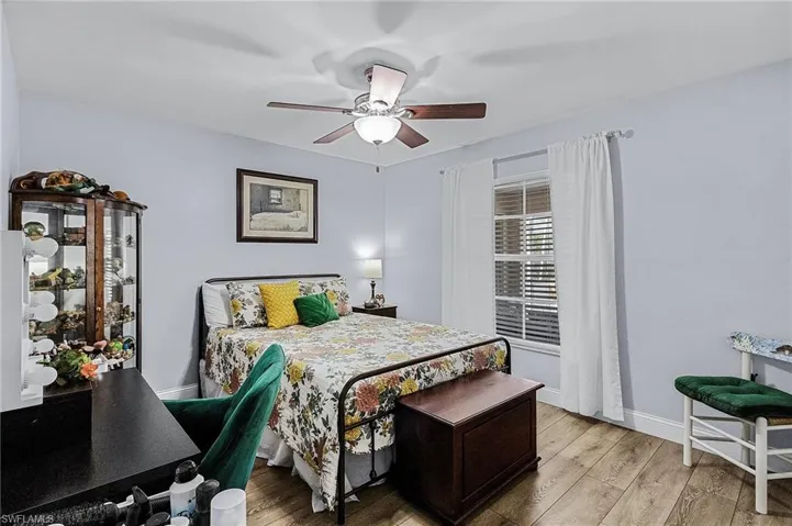Bedroom with light hardwood / wood-style floors and ceiling fan