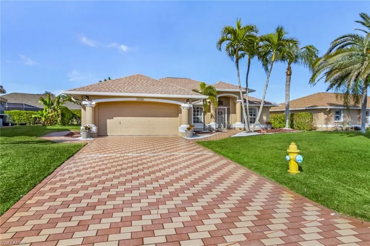 View of front of home featuring a garage and a front lawn