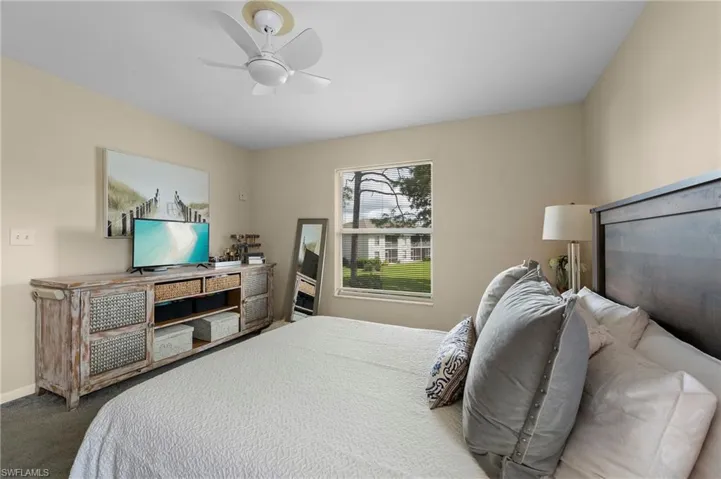Carpeted bedroom with ceiling fan