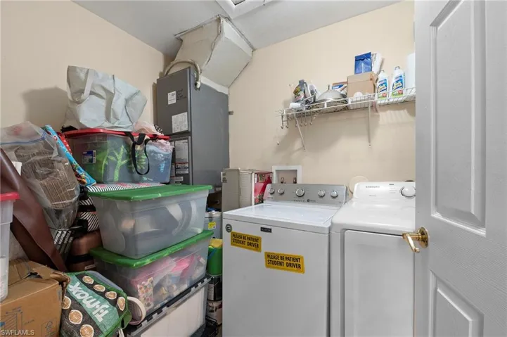 Clothes washing area featuring washer and dryer