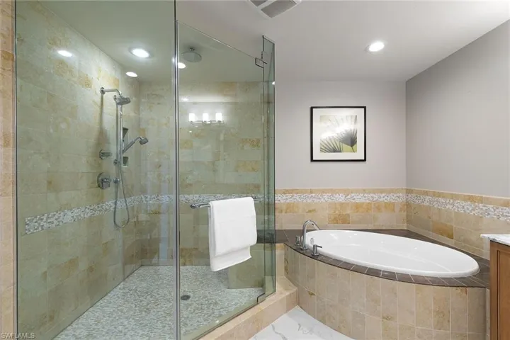 Bathroom featuring a bath, a shower stall, vanity, and recessed lighting