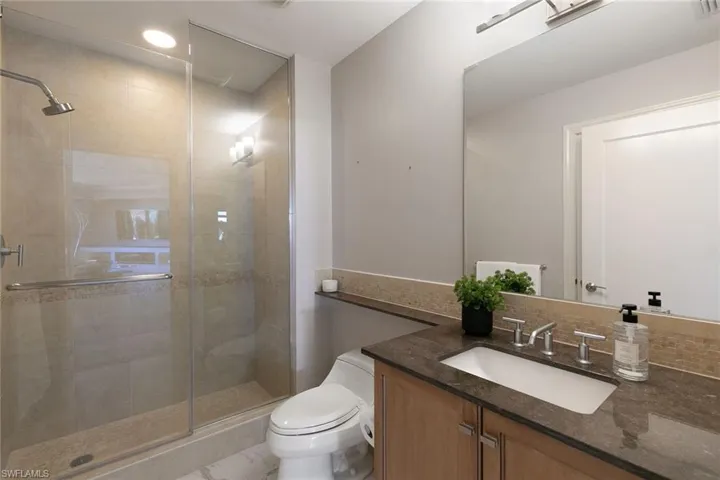 Bathroom with vanity and a shower stall