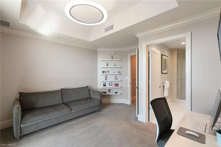 Home office with crown molding and light carpet