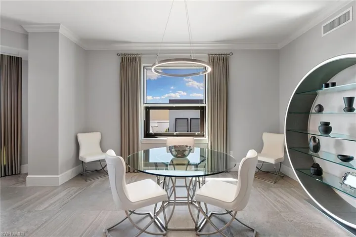 Dining area featuring crown molding