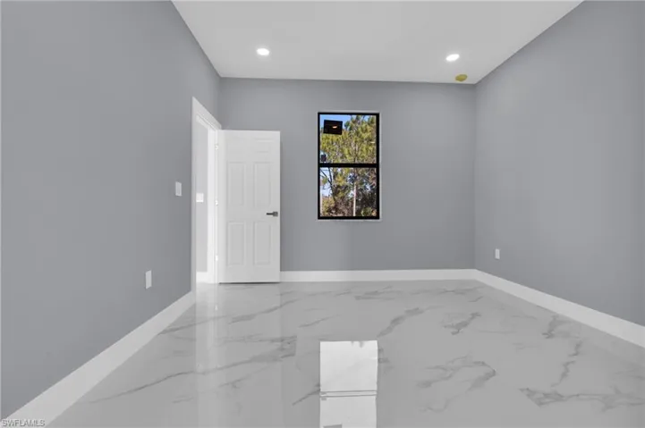 Unfurnished room featuring recessed lighting and light marble finish floors