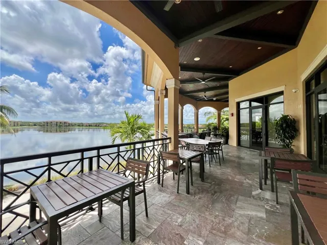 View of patio featuring ceiling fan, a water view, and outdoor dining space