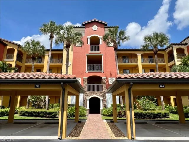 View of building exterior featuring covered parking