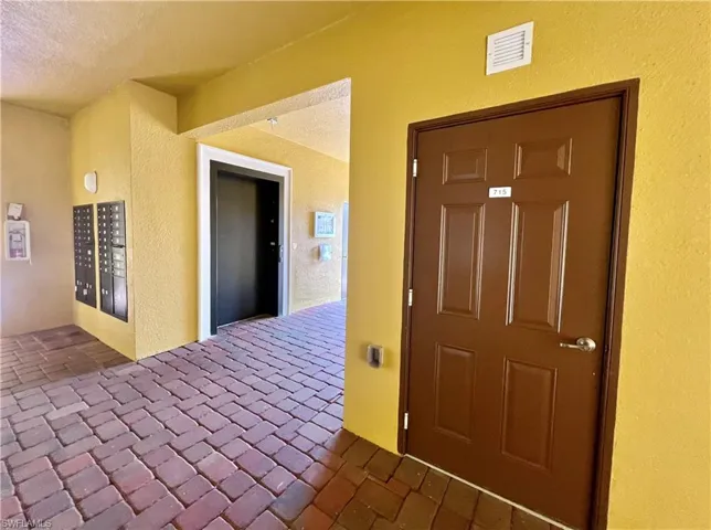 View of exterior storage featuring stucco siding