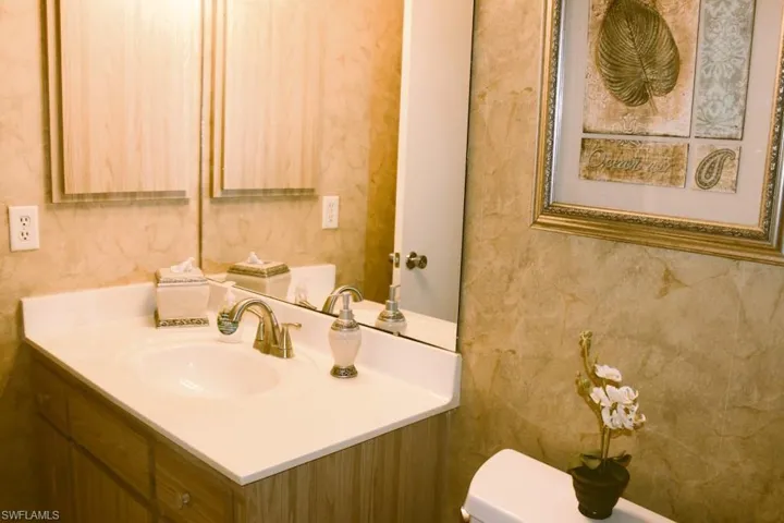 Half bathroom with vanity and toilet