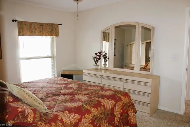 Bedroom featuring carpet flooring and arched walkways