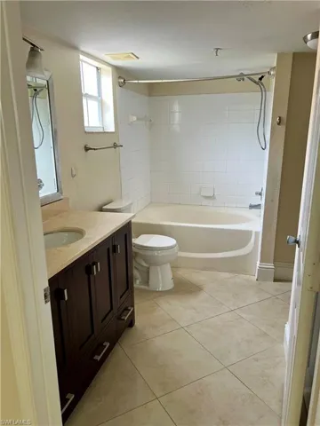 Bathroom featuring a dark wood-finish vanity with a light-toned countertop and integrated sink